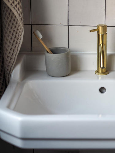 Stylish small handmade concrete pot in bathroom